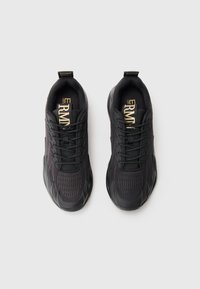 Pair of black athletic sneakers with mesh uppers, lace closures, and branded tongue labels placed side by side on a white background.