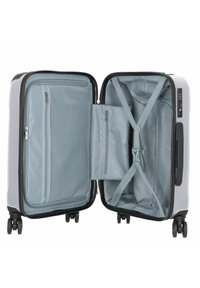 Harde handbagagekoffer met een lichtgrijze buitenkant, dubbele compartimenten, een mesh zak en verstelbare banden. Vier multidirectionele wielen.