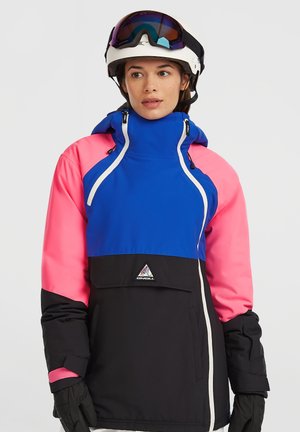 Colorful snowboard jacket featuring blue, pink, and black panels, with a high collar, adjustable hood, and triangular logo on the front.