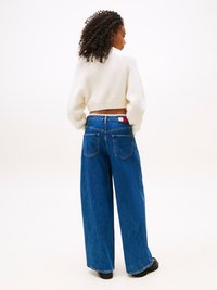 Light blue wide-leg jeans with a high waist, featuring two back pockets and a contrast waistband detail. Worn with a white cropped sweater.