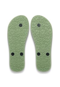 Πράσινες λαστιχένιες πάτοι με λουλουδάτο μοτίβο, διακοσμημένοι με μαύρους κυκλικούς δείκτες που αναγράφουν "R" και "L" για το δεξί και αριστερό πόδι.