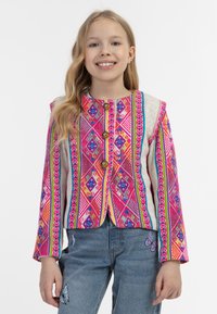 Spalvota raštuota striukė su rožiniais, violetiniais ir geltonais deimantais, turinti tris priekinės dalies sagas ir kontrastingas smėlio spalvos rankovės.