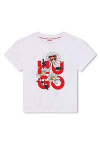 T-shirt en coton blanc avec un logo "HUGO" rouge orné de graphiques floraux, incluant des marguerites et des cœurs, et un col rond.