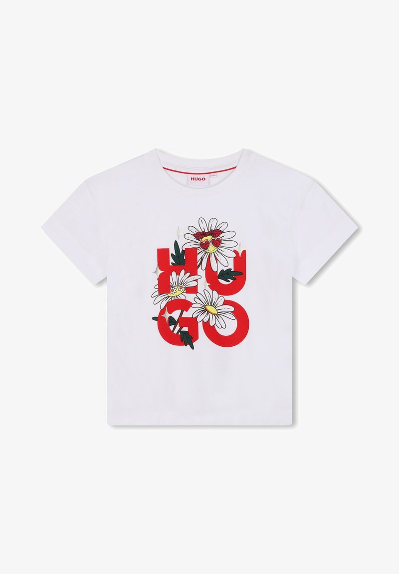 T-shirt en coton blanc avec un logo "HUGO" rouge orné de graphiques floraux, incluant des marguerites et des cœurs, et un col rond.