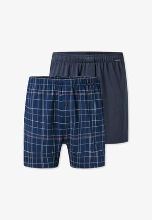 Two pairs of men's boxers: one navy blue solid, one navy with a white and pink grid pattern. Both have elastic waistbands.