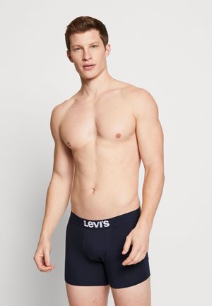 Marineblauwe katoenen boxershorts met een witte "Levi's" logo op de tailleband. Het ontwerp is aansluitend met een gladde textuur en een lengte tot halverwege de bovenbenen.
