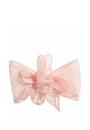 Hele roosa läbipaistev kangastuss, millel on mitu silmust ja keskel sõlm, omades õrna, õhulist tekstuuri.