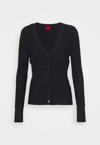 Svart ribbad kofta med långa ärmar, V-ringning, sex knappar framtill och scalloped fåll. Tillverkad av ett mjukt, strukturerat material.