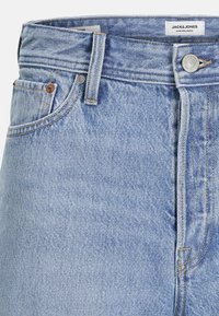 Jeanși din denim de culoare bleu deschis, cu talie înaltă, fixare normală, caracterizându-se prin cusături contrastante, un nasture metalic și un design clasic cu cinci buzunare.