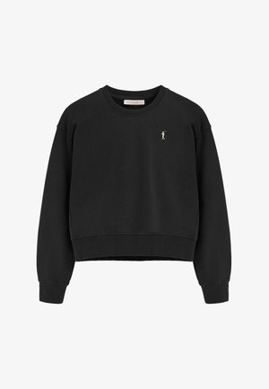 Sweatshirt noir court avec col rond, poignets et ourlet côtelés ; présente un petit logo doré brodé à l'avant. Matière douce.