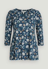 Tunika blu con maniche tre quarti, caratterizzata da un motivo di foglie in teal, marrone e bianco. Tessuto morbido con scollatura a V.