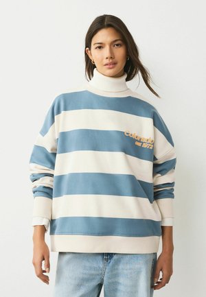 Striped sweatshirt in blue and cream, featuring a high neck and ribbed cuffs. Includes "Colorado est 1972" embroidered detail.