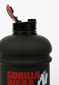 Black, textured water bottle with a red flip-top lid. Features a printed logo in white and red, and a wide body design for grip.