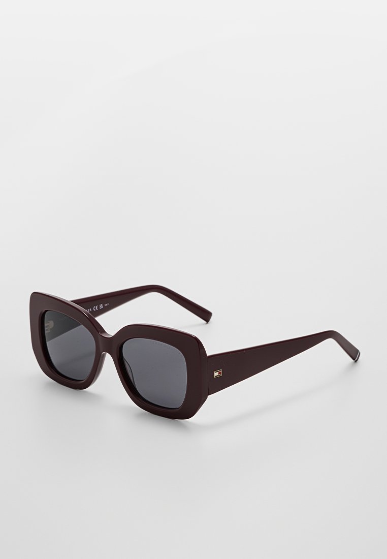 Square sunglasses with a deep burgundy plastic frame and dark lenses. Features a subtle brand logo on the temple.