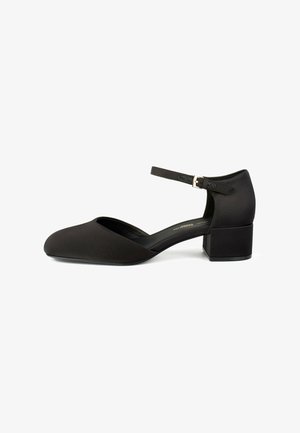 Black satin pump with a rounded toe, ankle strap, and a block heel. Smooth texture with a minimalistic design.