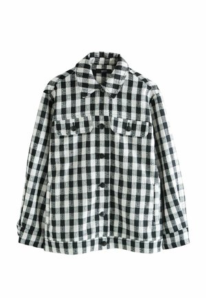 Black and white checkered shirt jacket made of textured fabric, featuring a collar, two front pockets, and button closures.