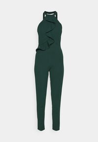 Mörkgrön jumpsuit med halterneck och volangdetalj framtill. Tillverkad av ett mjukt, stretchigt material, med figurnära ben och minimiackenter.