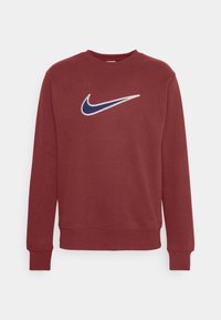 Marinfärgad långärmad crewneck-tröja med en centralt placerad Swoosh-logotyp i marinblått och vitt från Nike på bröstet.