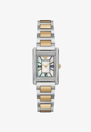 Jam tangan berbentuk persegi panjang dengan gelang perak dan emas. Memiliki wajah berwarna mutiara, penanda jam hitam, dan bezel yang dihiasi berlian.