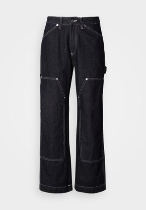 Dark denim trousers with a wide-leg design, featuring multiple pockets, white stitching accents, and a button closure at the waist.