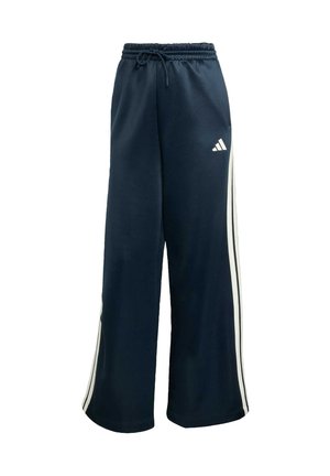 Navy joggings met een losse pasvorm, gemaakt van zachte stof. Voorzien van witte zijstrepen en een elastische tailleband met een trekkoord. Adidas-logo aanwezig.