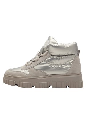 Jasnobeżowy sneaker za kostkę z puszystą nylonową cholewką, zamszowym noskiem i piętą, grubą gumową podeszwą i sznurowaniem z przodu.