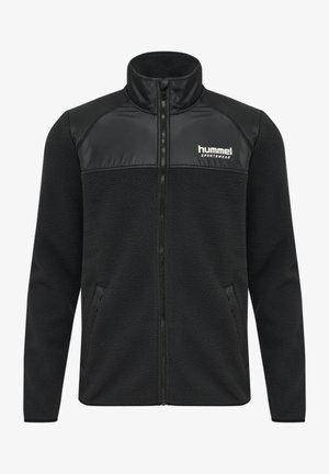 Czarna polarowa kurtka z kołnierzem typu mock, zapinana na zamek z przodu, o fakturowanym materiale. Posiada gładką czarną górną część oraz boczne kieszenie. Logo Hummel na piersi.