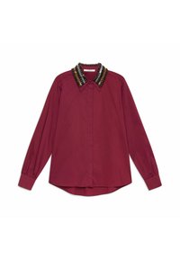 Maroon long-sleeve shirt with a beaded collar featuring black, gold, and metallic accents; soft texture; button-down front; curved hem.