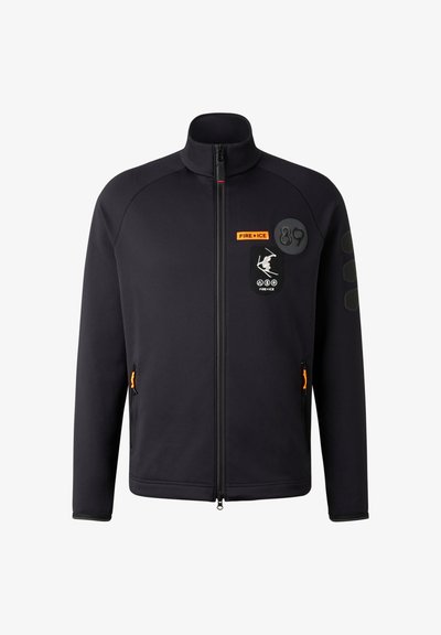 Black zip-up jacket with stand collar, featuring orange accents, logos, and patches, and textured shoulder details. Front zip pockets included.