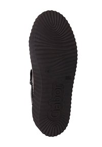 Semelle de chaussure en caoutchouc noir avec un motif de chaussée ondulé et un logo de marque en relief. Texture lisse avec des rainures offrant une adhérence.
