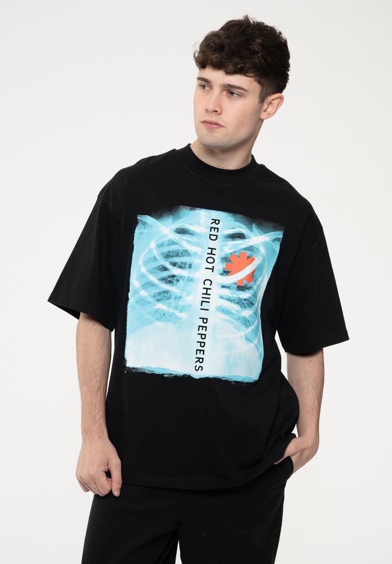 Black cotton t-shirt featuring a graphic print of an x-ray design with blue tones and the text "RED HOT CHILI PEPPERS" in white.