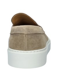 Suede slip-on shoes in light brown, featuring a white platform sole and rounded heel. Soft texture with minimal stitching detail.