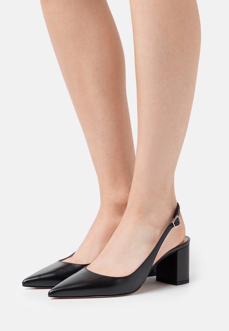Black leather slingback heels with a pointed toe and chunky block heel, featuring a minimal design and smooth texture.