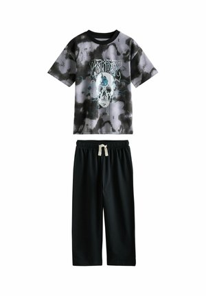 Black and gray tie-dye pajama set featuring a short-sleeve T-shirt with a skull graphic and black shorts with an elastic waistband and drawstring.