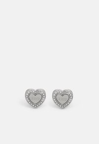 Silver heart-shaped stud earrings featuring a center with the engraved brand name and surrounded by small clear gemstones.