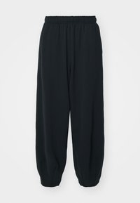Svarta, avslappnade sweatpants i normal passform med resårmidja, smalnande ärmslut och en slät textur. Minimalistisk design, inga synliga mönster eller detaljer.
