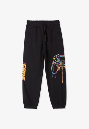 Czarne spodnie dresowe z bawełny z elastycznymi mankietami, ozdobione kolorową grafiką kontrolera do gier oraz napisem "GAME" w żywych literach.