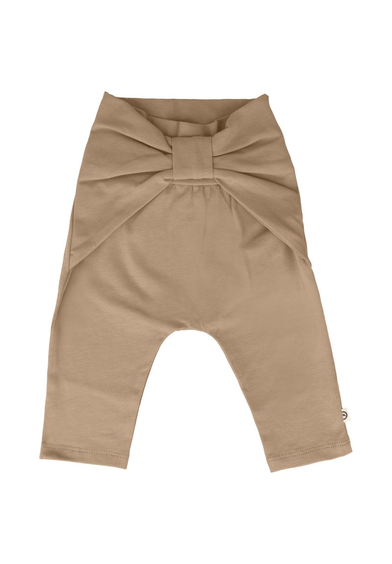 Pantalon en coton beige avec un grand détail en nœud à la taille, jambes fuselées et texture lisse. Présente une petite étiquette sur le côté.