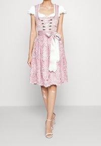 Lyserød blonde dirndl-kjole med en tætsiddende overdel, snørret foran og knælang nederdel udsmykket med blomster mønstre, der har et satinbånd til at binde.