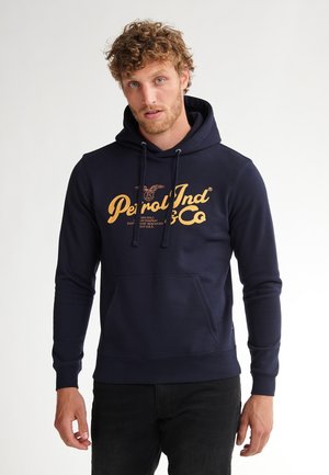 Navy blue hoodie made of cotton blend fabric, featuring a front kangaroo pocket and a gold graphic logo on the chest. Drawstrings at the hood.