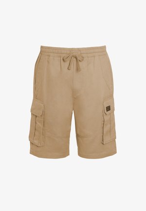 Beige cotton cargo shorts with an elastic waistband, drawstring, and multiple side pockets. Textured fabric with stitched accents.