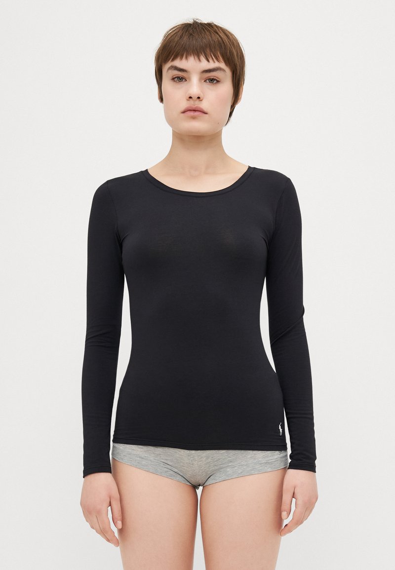 Black long-sleeve shirt made of soft, smooth fabric. Features a round neckline and a slim fit, paired with gray shorts.