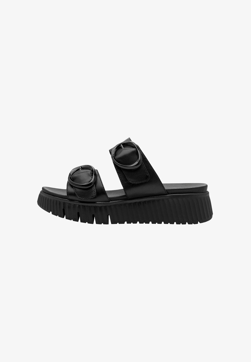 Sandales slides en cuir noir avec deux boucles circulaires, semelle épaisse nervurée, design à bout ouvert et texture lisse.