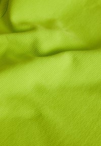 Bright lime green ribbed fabric with soft folds and a smooth, textured surface.