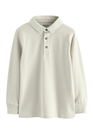 Polo shirt beige clair à manches longues en tissu texturé, avec un col classique, une patte de boutonnage à trois boutons et des poignets côtelés.