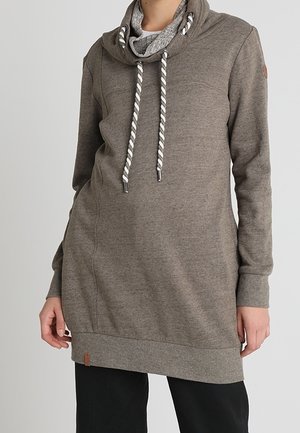 Long-sleeve taupe pullover with high collar and white-striped drawstrings, worn over black pants, shown from neck to mid-thigh.