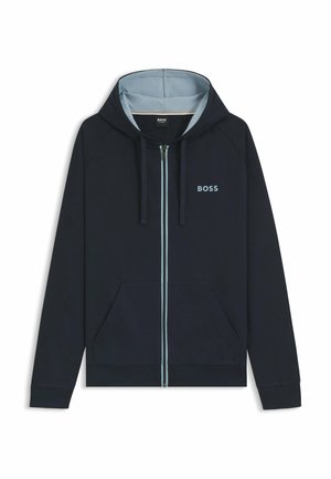 Felpa con zip di un blu navy scuro, dotata di una fodera interna leggera blu chiaro, tasche frontali e un piccolo logo ricamato sul petto. Tessuto strutturato.