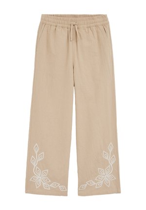 Pantalon beige à jambes larges avec taille élastique et cordon de serrage, ornée de broderies florales blanches près des ourlets inférieurs sur les deux jambes.