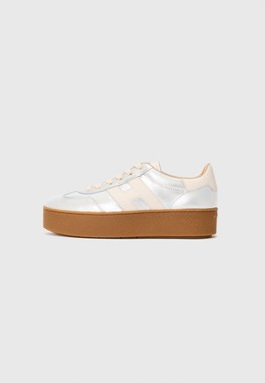 White and beige leather platform sneaker with thick brown sole and lace-up front, side showing stitched "H" detail on neutral background.