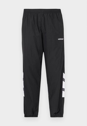 Sorte vindtætte bukser med elastisk talje, tilspidsede manchetter og hvidt trestribet design på siderne. Fremstillet af let, glat materiale.